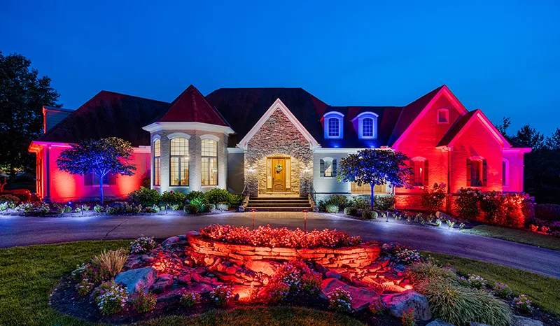 The same home lit with Green Lighting LED landscape lighting at night